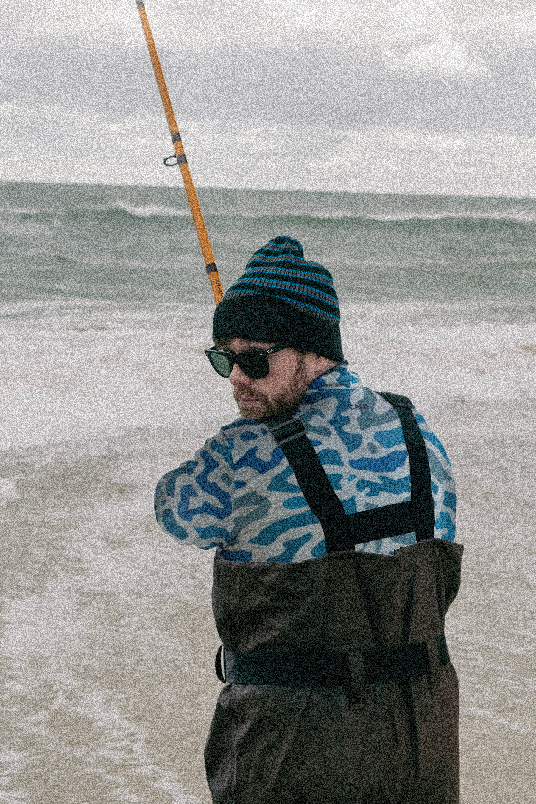 Fishing in the surf with camo sun hoodie at the outerbanks